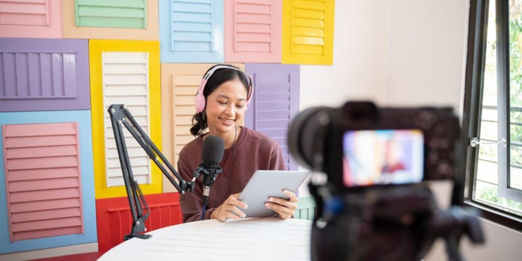 A woman recording a YouTube podcast