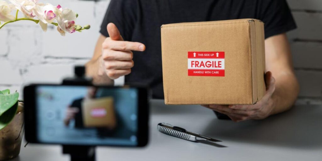 A man recording a product unboxing video