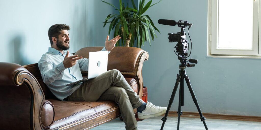 A video vlogger sitting in front of a camera